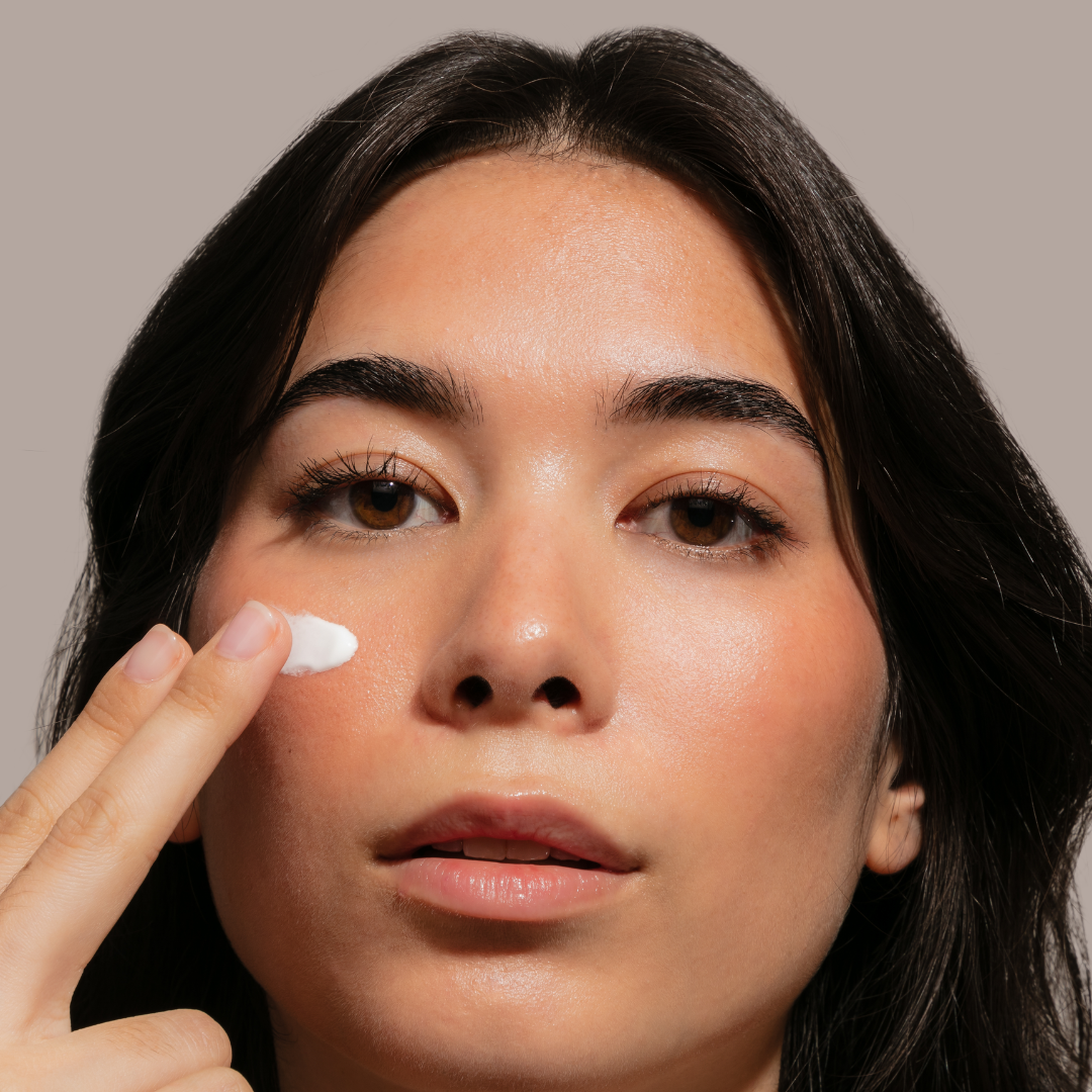 Model putting sunscreen on her cheek